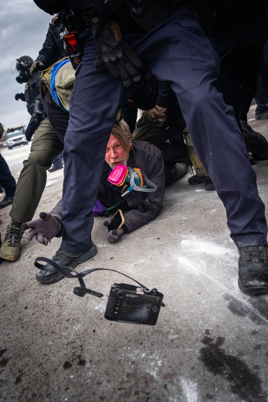 Photographer John Abernathy says he tossed his camera to Pierre Lavie so it wouldn't be confiscated by federal officers.