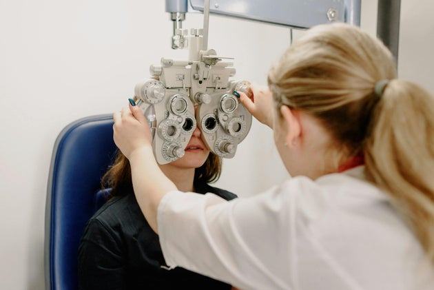 ophthalmologist checking vision of patient