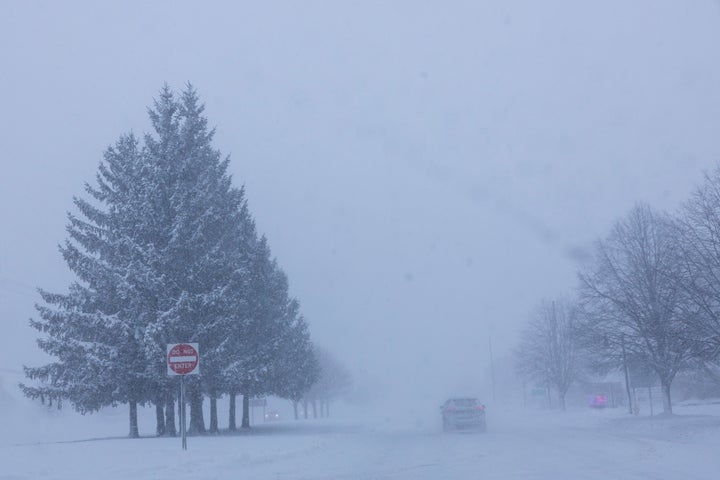 Vehicles are driven through whiteout conditions along Lake Michigan Drive during a winter storm warning in Ottawa County, Mich. on Monday, Jan. 19, 2026. (Joel Bissell/Kalamazoo Gazette via AP)