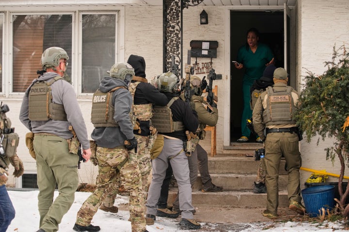 Teyana Gibson Brown, second from right, wife of Garrison Gibson, reacts after a federal immigration officer used a battering ram to break down a door before arresting Garrison Gibson, Sunday, Jan. 11, 2026, in Minneapolis. (AP Photo/John Locher)