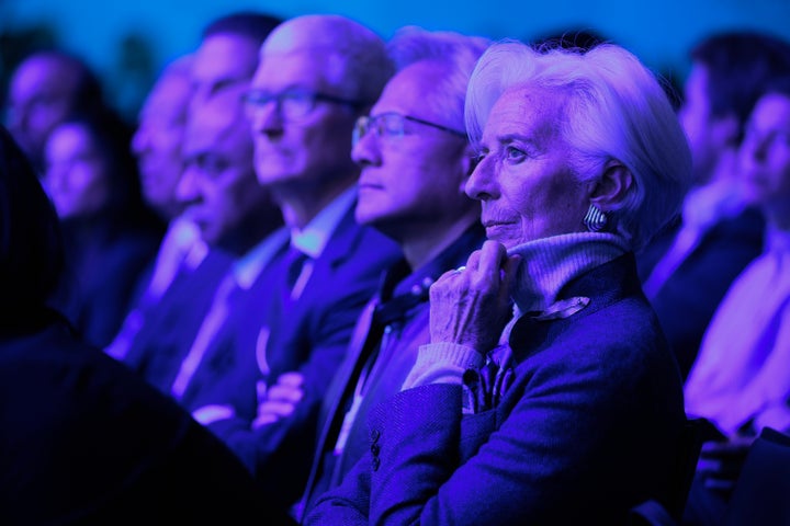 DAVOS, SWITZERLAND - JANUARY 21: Delegates including (L-R) CEO of Apple Tim Cook, President and CEO of NVIDIA Jensen Huang and President of the European Central Bank Christine Lagarde watch as U.S. President Donald Trump gives a speech at the World Economic Forum (WEF) on January 21, 2026 in Davos, Switzerland.(Photo by Chip Somodevilla/Getty Images)