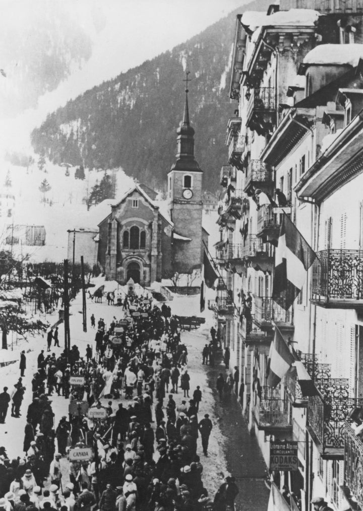 Delegates from the competing nations gather near the Saint-Michel church and the Hotel de Ville for the opening ceremony.