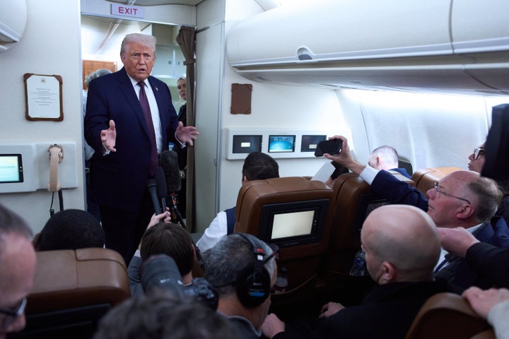 President Donald Trump speaks with reporters aboard Air Force One after leaving the World Economic Forum in Switzerland on Jan. 22, 2026.