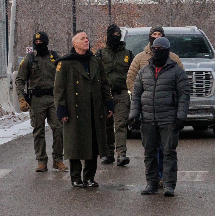 Gregory Bovino (second from left) wore his green trenchcoat while visiting Minneapolis this week.