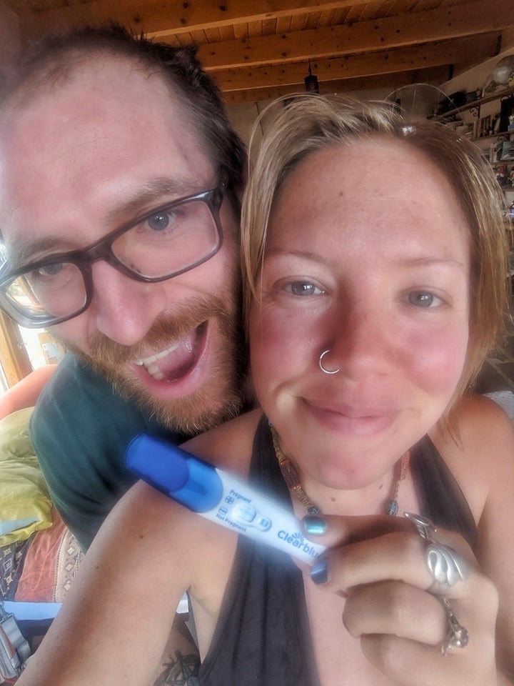 The author holding a positive pregnancy test.