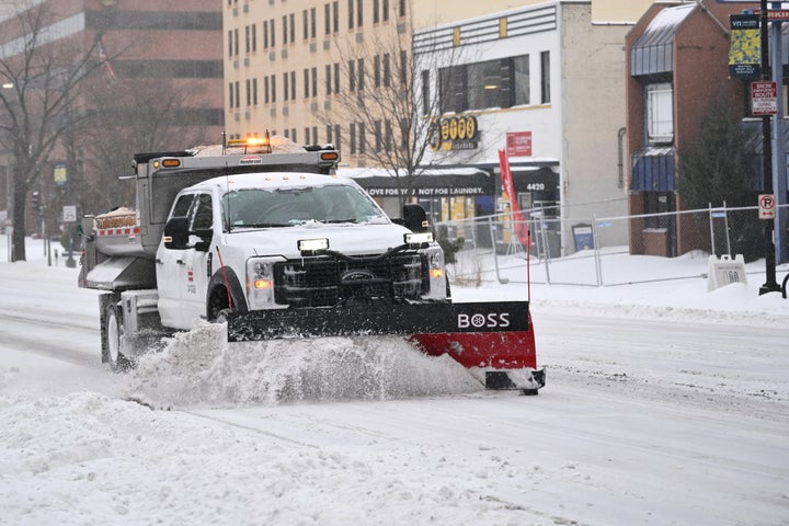 A truck with a plow clears snow from a street in Washington, DC on January 25, 2026. A massive winter storm on January 24 dumped snow and freezing rain from New Mexico to North Carolina as it swept across the United States towards the northeast, threatening tens of millions of Americans with blackouts, transportation chaos and bone-chilling cold. After battering the country's southwest and central areas, the storm system began to hit the heavily populated mid-Atlantic and northeastern states as a frigid air mass settled in across the nation. (Photo by Mandel NGAN / AFP via Getty Images)