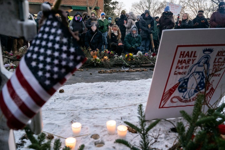 People mourn at a makeshift memorial in the area where Pretti was shot.