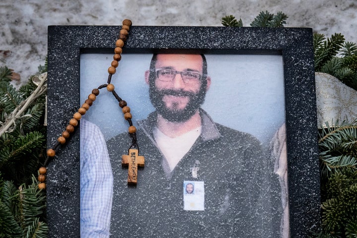 TOPSHOT - A rosary adorns a framed photo Alex Pretti that was left at a makeshift memorial in the area where Pretti was shot dead a day earlier by federal immigration agents in Minneapolis, Minnesota, on January 25, 2026. On January 24, federal agents shot dead US citizen Alex Pretti, a 37-year-old ICU nurse, while scuffling with him on an icy roadway, less than three weeks after an immigration officer shot and killed Renee Good, also 37, in her car.His killing sparked new protests and impassioned demands by local leaders for the Trump administration to end its operation in the city. (Photo by ROBERTO SCHMIDT / AFP via Getty Images)