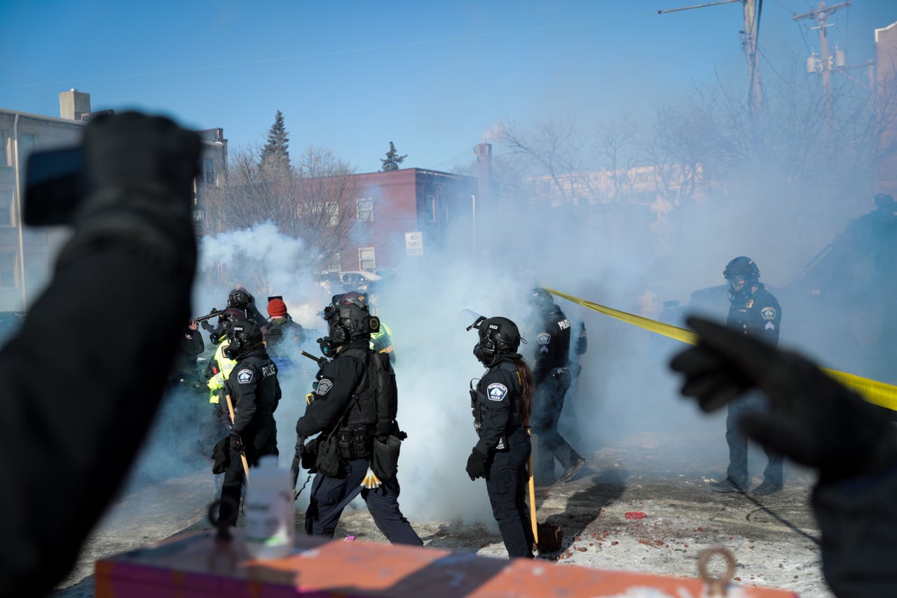 Protesters form a makeshift barricade with trash bins and a mattress during demonstrations in Minneapolis on Saturday.