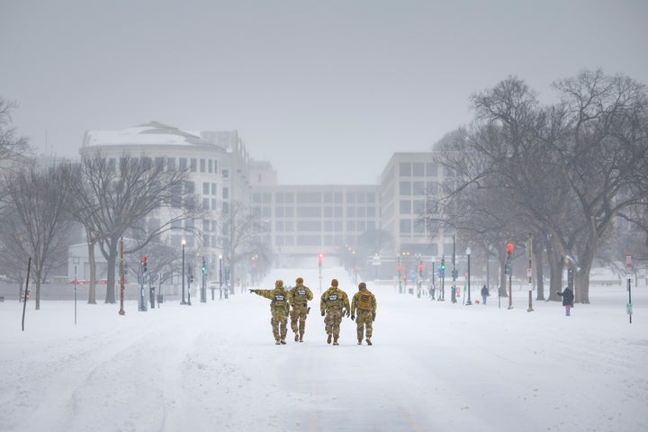 Members of the Mississippi National Guard walk along a snow covered 3rd Street NW in Washington, on Jan. 25, 2026.