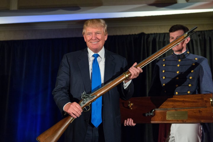 Trump holds up a replica flintlock rifle awarded to him by cadets during the Republican Society Patriot Dinner in 2015 in Charleston, South Carolina.