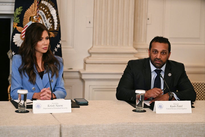 Homeland Security Secretary Kristi Noem (L) listens to FBI Director Kash Patel speak during a White House roundtable on Antifa in October 2025.