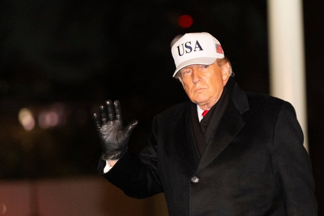 President Donald Trump waves as he walks from Marine One after arriving on the South Lawn of the White House, Tuesday, Jan. 27, 2026, in Washington.