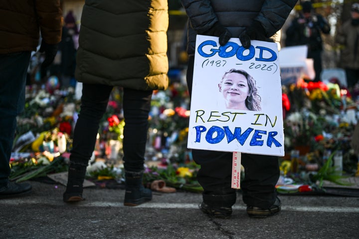 A person holds a sign reading "Good: Rest in Power" during a vigil at a memorial near the site where Renee Good was fatally shot on Jan. 14 in Minneapolis.