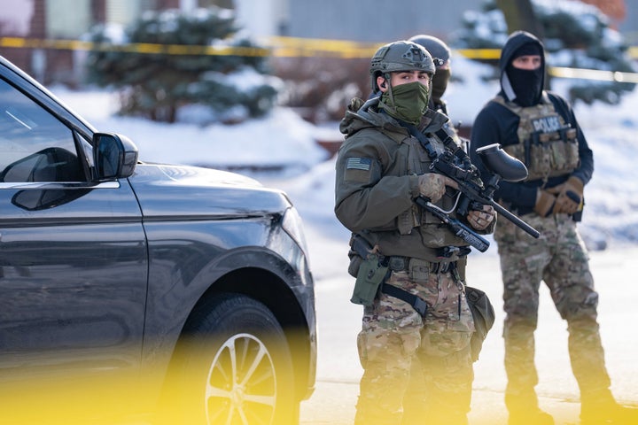 Federal agents including ICE and U.S. Border Patrol stand with weapons along Portland Ave. near the scene where federal agents shot and killed a woman earlier in Minneapolis, Minn. on Wednesday, January 7, 2026. (Photo by Alex Kormann/The Minnesota Star Tribune via Getty Images)