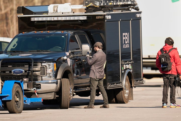 FBI officers are seen at the Fulton County Election Hub and Operation Center, Wednesday, Jan. 28, 2026, in Union City, Ga, near Atlanta. (AP Photo/Mike Stewart)