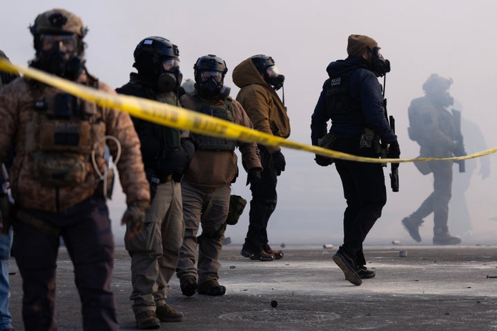 Federal agents stand in tear gas and face protesters on Nicollet Avenue near West 26th St. in south Minneapolis after Alex Pretti was fatally shot by federal agents in the area early Saturday morning, Jan. 24, 2026.