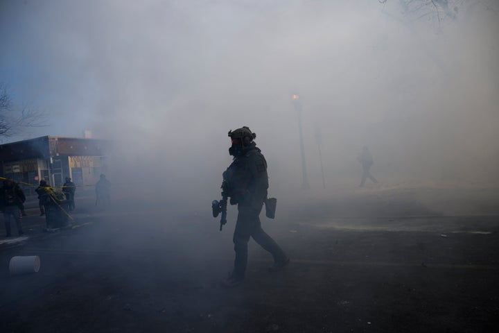 Tear gas fills the air on Nicollet Avenue near West 27th Street in south Minneapolis after Alex Pretti was fatally shot by federal agents in the area early Saturday morning.