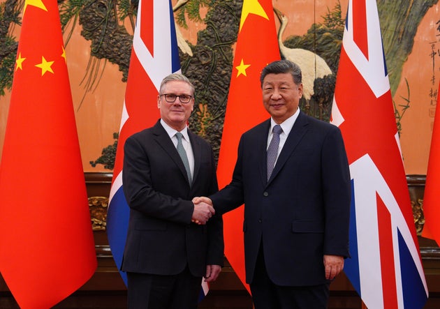 Britain's Prime Minister Keir Starmer, left, shakes hands with Chinese President Xi Jinping ahead of a bilateral meeting in Beijing, China, Thursday, Jan.29, 2026. (Carl Court/Pool Photo via AP)