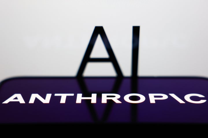 AI sign displayed on a screen and Anthropic logo displayed on a phone screen are seen in this illustration photo taken in Krakow, Poland on December 26, 2025. (Photo by Jakub Porzycki/NurPhoto via Getty Images)