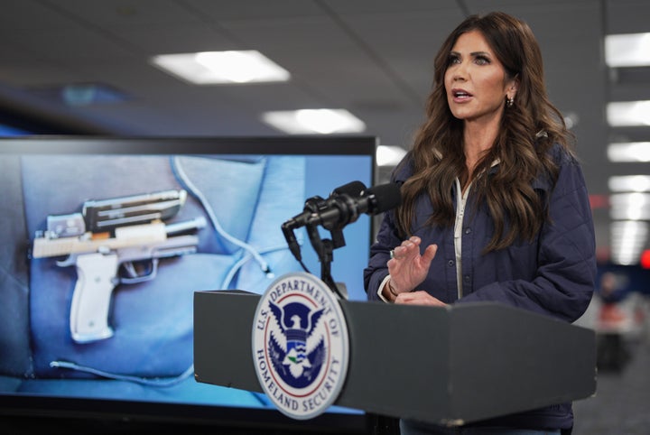 A photograph of the pistol recovered by immigration agents after a shooting in Minneapolis, Minnesota on Saturday morning is shown on a screen behind U.S. Secretary of Homeland Security Kristi Noem as she speaks during a news conference in the National Response Coordination Center at the Federal Emergency Management Agency (FEMA) headquarters on Jan. 24, 2026 in Washington, D.C.