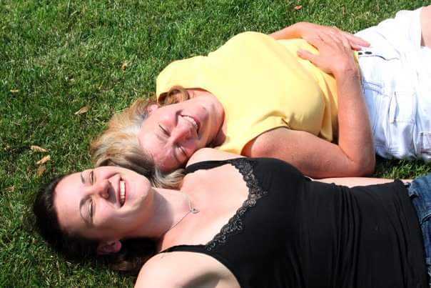 The author and her mom laying on the grass in Chicago, a few months after the abortion procedure.