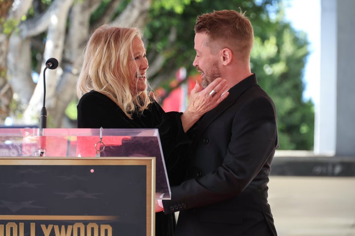 Catherine O'Hara (left) and Macaulay Culkin speak on stage during the ceremony honoring Macaulay Culkin with a star on the Hollywood Walk of Fame on December 1, 2023 in Hollywood, California.