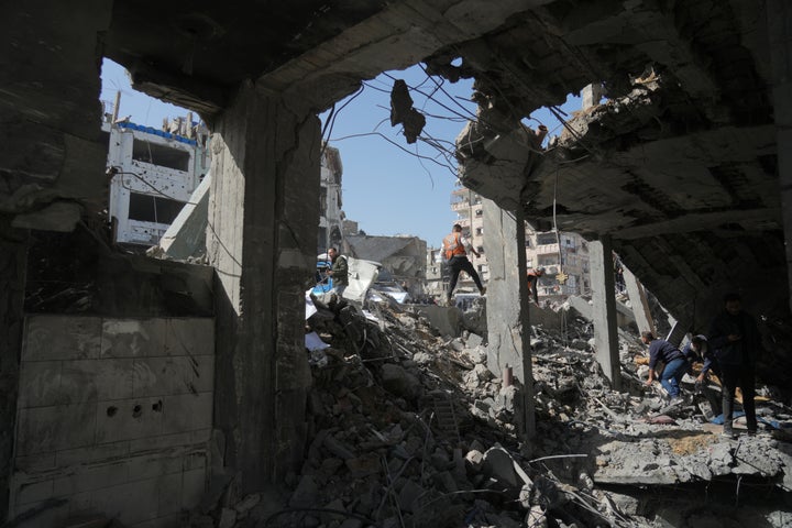 Palestinians search for bodies and survivors from the rubble of a police station after it was targeted by an Israeli army strike in Gaza City Saturday, Jan. 31, 2026. (AP Photo/Jehad Alshrafi)