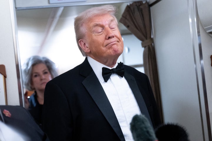President Donald Trump speaks to members of the media aboard Air Force One on Saturday.
