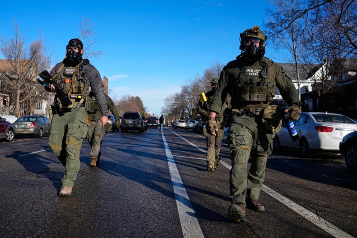 Federal immigration officers are seen near the scene where Renee Good was fatally shot by an ICE officer last week, Tuesday, Jan. 13, 2026, in Minneapolis. (AP Photo/John Locher)