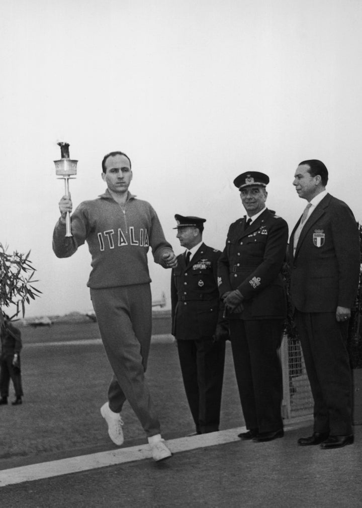 Italian athlete Giuseppe Dordone arrives with the Olympic flame at Ciampino Airport in Rome.