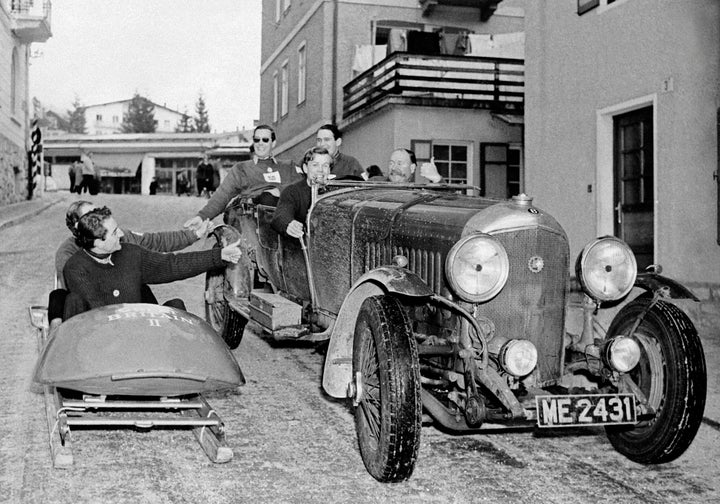 Britain's two-man bobsleigh team greeting passengers in a Bentley on the eve of the Games' opening ceremony.