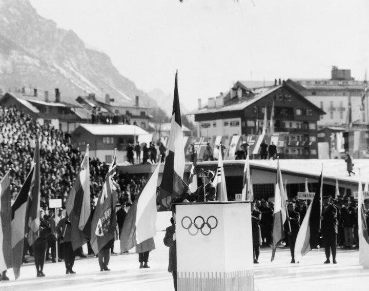 Italian Alpine skier Giuliana Chenal-Minuzzo reads the Olympic oath at the opening ceremony.