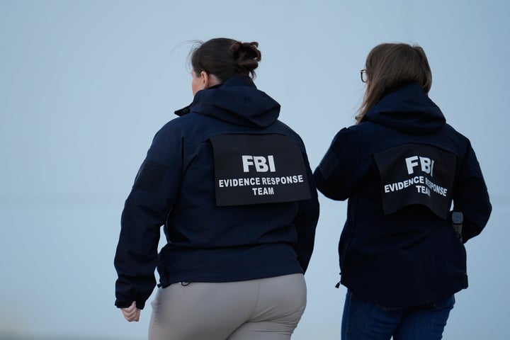 FBI officers are seen at the Fulton County Election Hub and Operation Center, Wednesday, Jan. 28, 2026, in Union City, Ga, near Atlanta. (AP Photo/Mike Stewart)