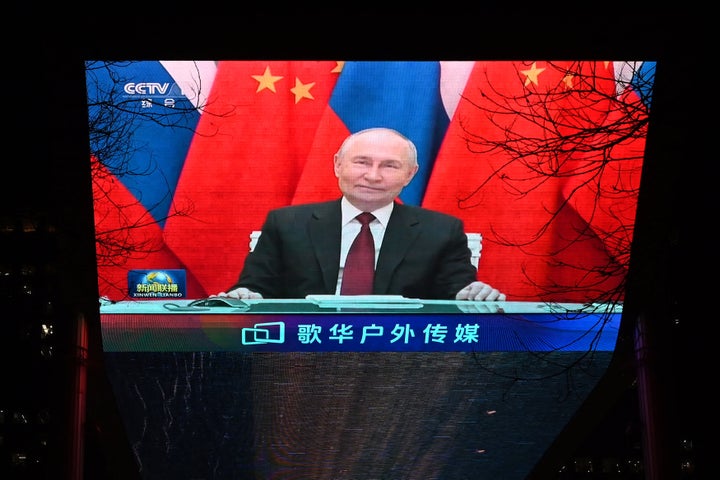 Russian President Vladimir Putin is seen during news coverage about a video call between Putin and Chinese President Xi Jinping in Beijing on Wednesday.
