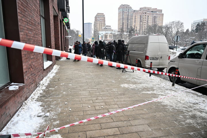 Media representatives gather in front of a high-rise residential building, the scene of an assassination attempt on Russian Lieutenant General Vladimir Alekseyev, in Moscow on February 6, 2026. (Photo by Hector RETAMAL / AFP via Getty Images)