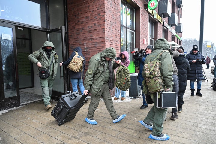 Investigators leave a high-rise residential building, the scene of an assassination attempt on Russian Lieutenant General Vladimir Alekseyev, in Moscow on February 6, 2026. (Photo by Hector RETAMAL / AFP via Getty Images)