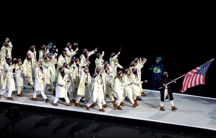 Flag bearer Erin Jackson of Team USA enters the parade of athletes with her team during the opening ceremony of the Milano Cortina 2026 Olympic Winter Games at San Siro Stadium.