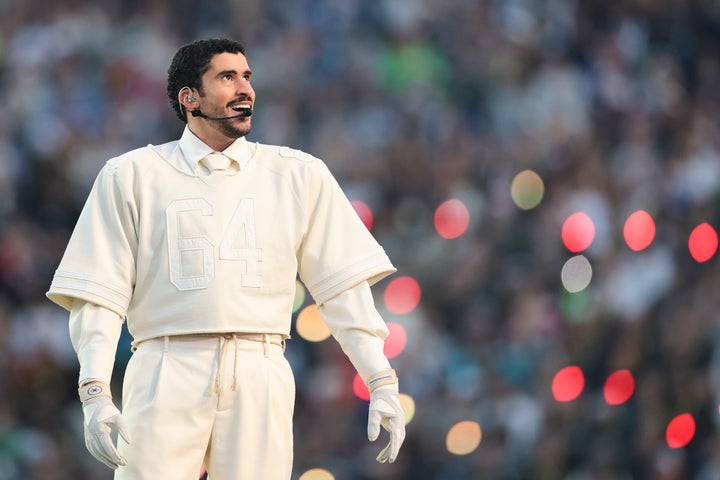 Bad Bunny laughs during a halftime performance of Super Bowl LX. 