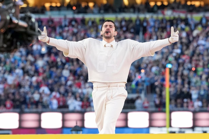 Bad Bunny wore a jersey bearing the number "64" in white during his performance. 