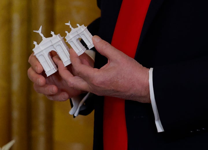 One of Trump's more recent props, a model of an arch he used during a fundraising dinner for his White House ballroom project.