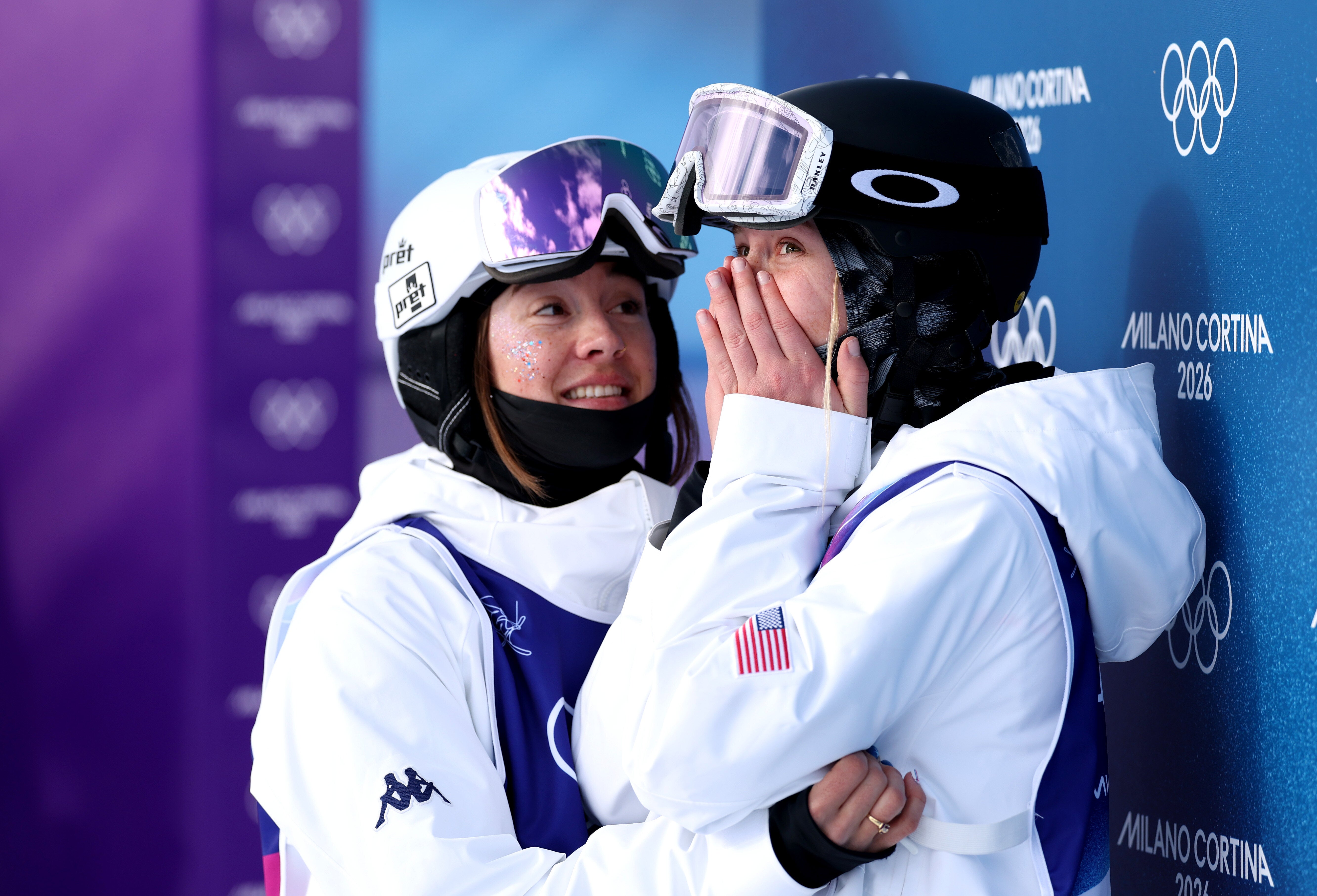 Silver medalist Jaelin Kauf (left) embraces her gold medal-winning teammate Elizabeth Lemley (right) after the latter skier's win in the women's moguls superfinal on Wednesday in Livigno, Italy.