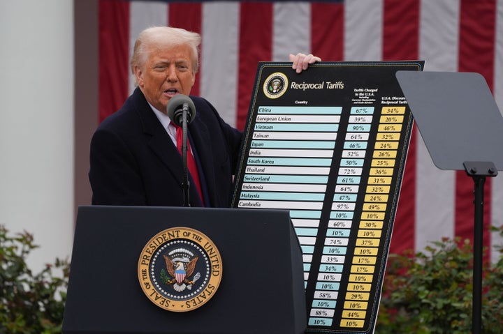 Washington, DC - April 2: President Donald Trump holds a chart as he announces a plan for tariffs on imported goods during an event Wednesday, April 2, 2025, in the Rose Garden at the White House. At right is Commerce Secretary Howard Lutnick. (Photo by Demetrius Freeman/The Washington Post via Getty Images)