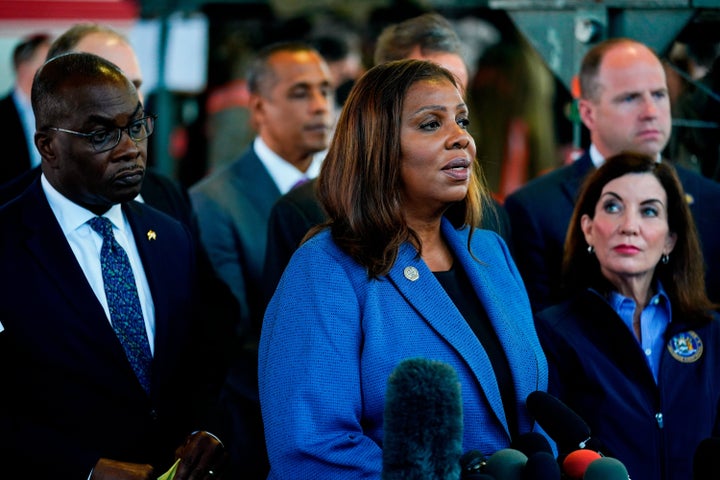 The maker of a gun accessory tied to a racist shooting that killed 10 Black people at a supermarket in Buffalo will pay $1.75 million to survivors and victims' families and stop selling the device in New York, state Attorney General Letitia James, center, said Wednesday.