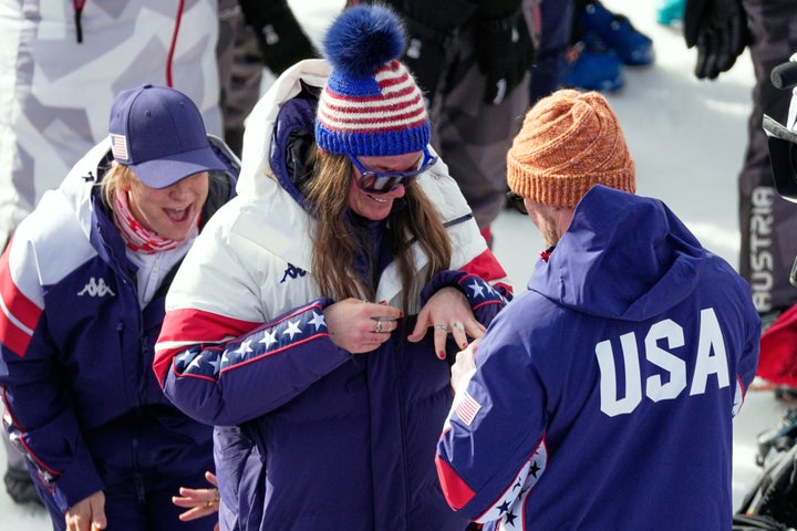 Breezy Johnson looks at the engagement ring that Connor Watkins gave him in the finish area in Cortina d'Ampezzo.