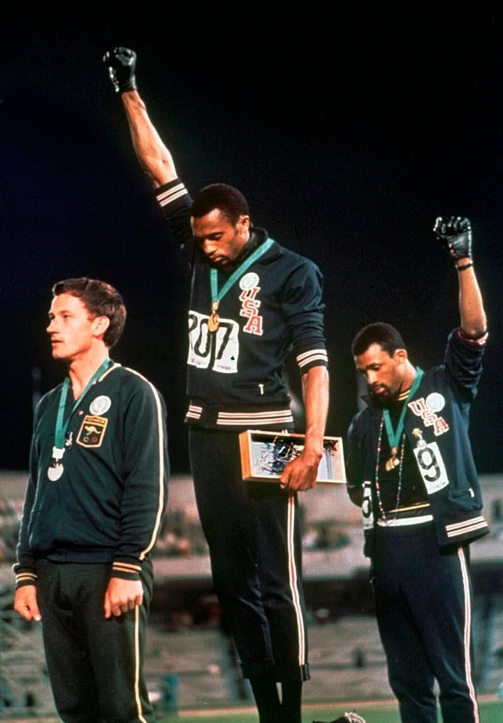 U.S. athletes Tommie Smith, center, and John Carlos extend gloved hands skyward in one of the notable Olympic protests at the Mexico City Games in 1968. 