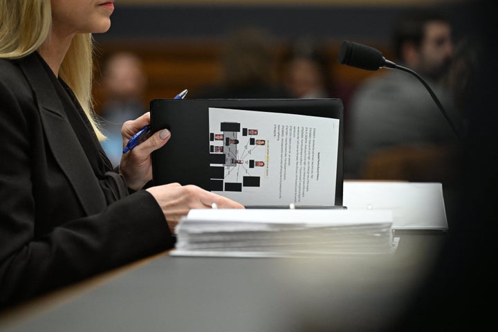 Attorney General Pam Bondi flips through her binder before testifying in front of a House Judiciary Committee hearing on Feb. 11, 2026. 