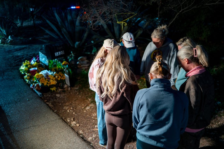 People gather at a prayer vigil for Nancy Guthrie at the entrance to her residence Thursday.