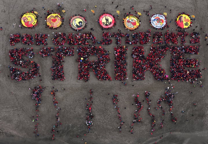 In an aerial view, striking San Francisco Unified School District teachers and students form a human banner spelling out 'STRIKE' at Ocean Beach on February 11, 2026 in San Francisco, California. (Photo by Justin Sullivan/Getty Images)