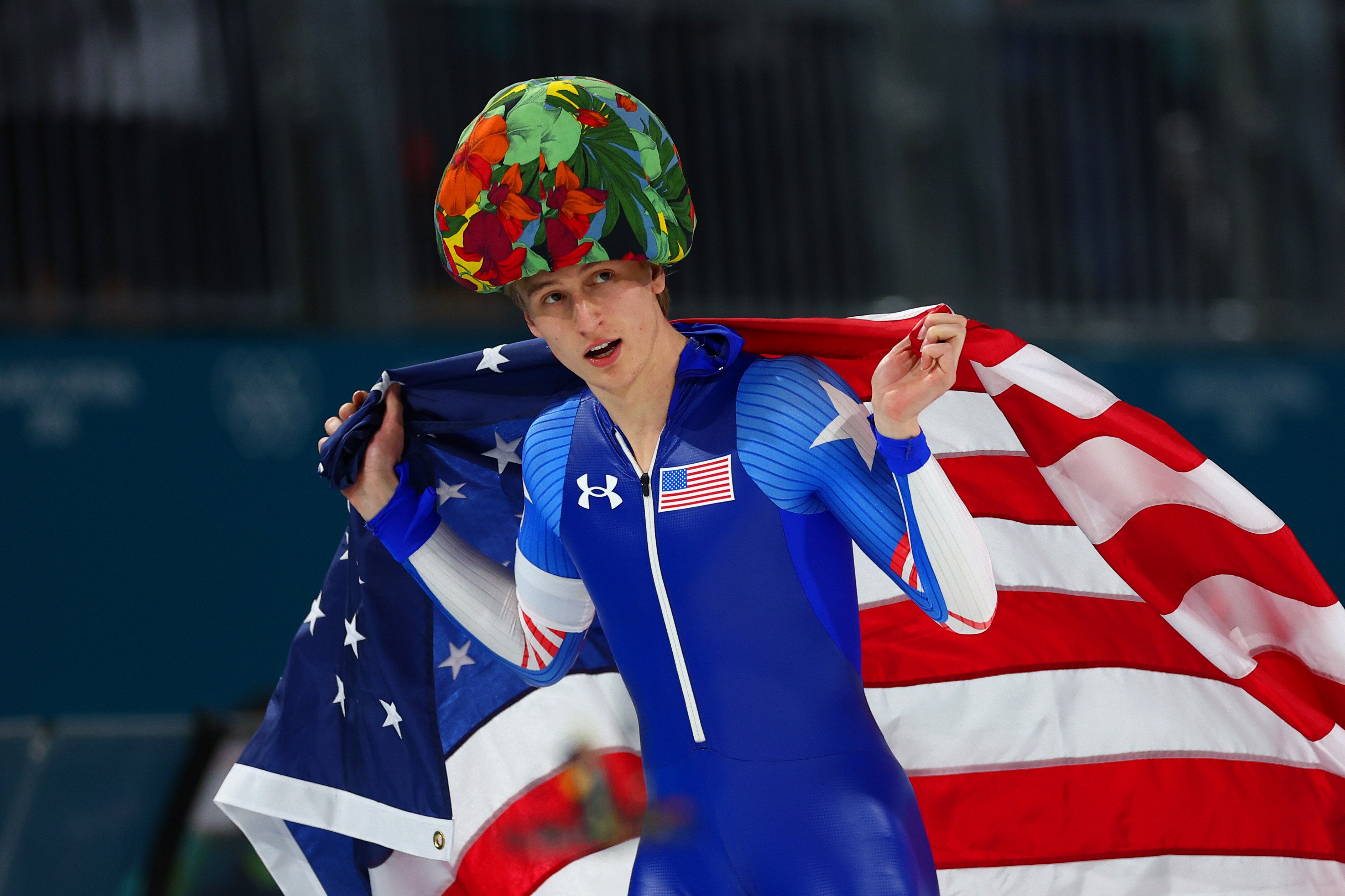 Jordan Stolz rocks the flower hat which is apparently tossed to winners of the speedskating events. 